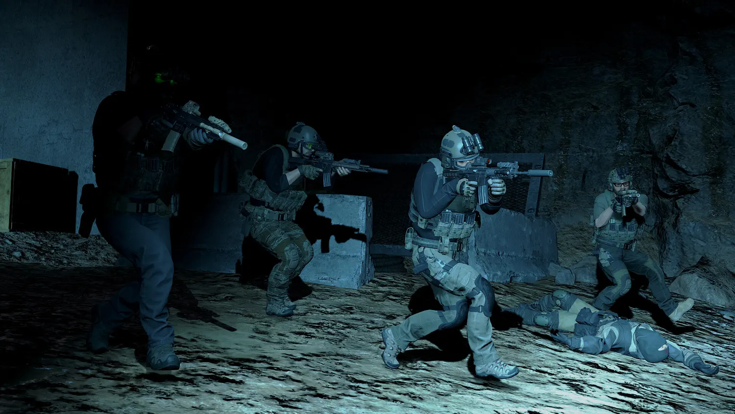 A team of operators with night-vision and suppressed rifles clearing a dark interior in Ground Branch
