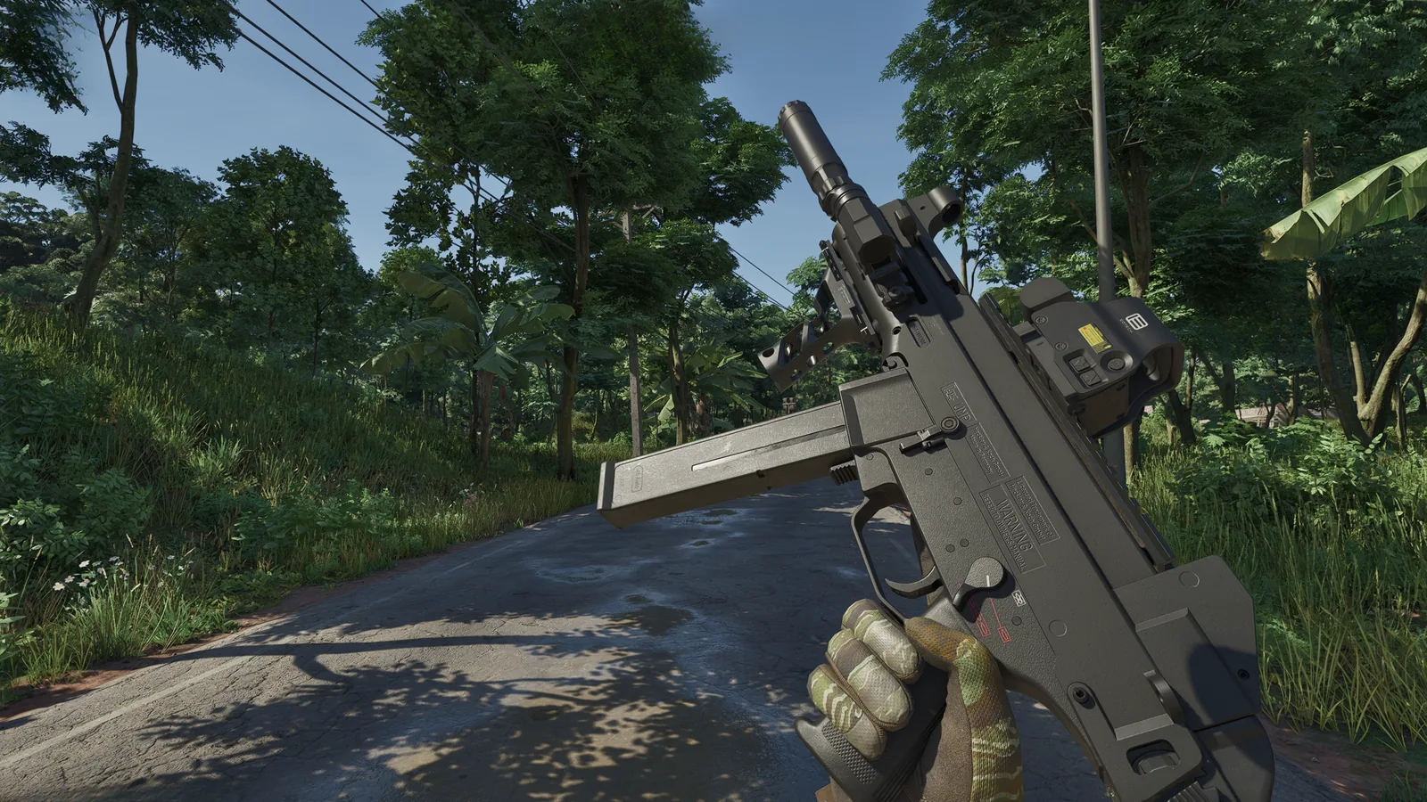 First-person view of a suppressed UMP with a holographic sight on a jungle road in Gray Zone Warfare 0.5